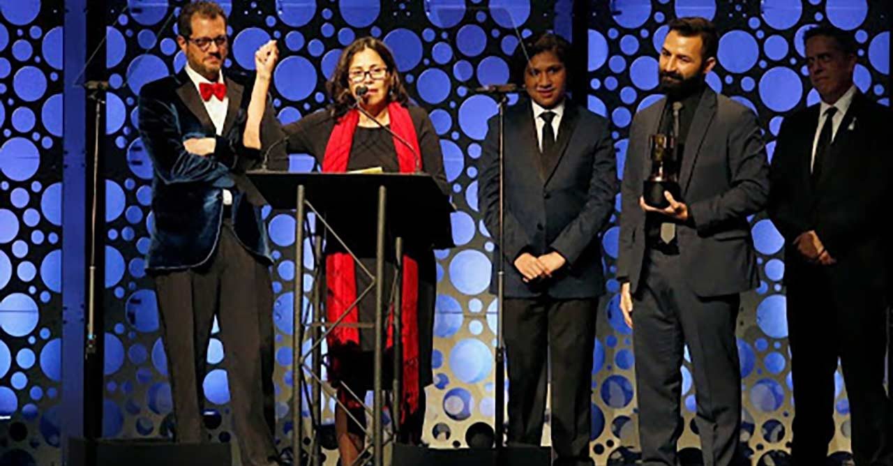 group of people on stage at award show